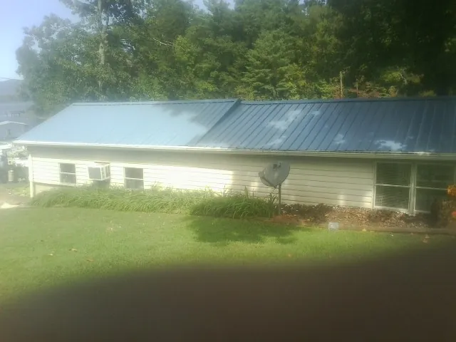 Blue metal roof running the length of a single story home in Ranson