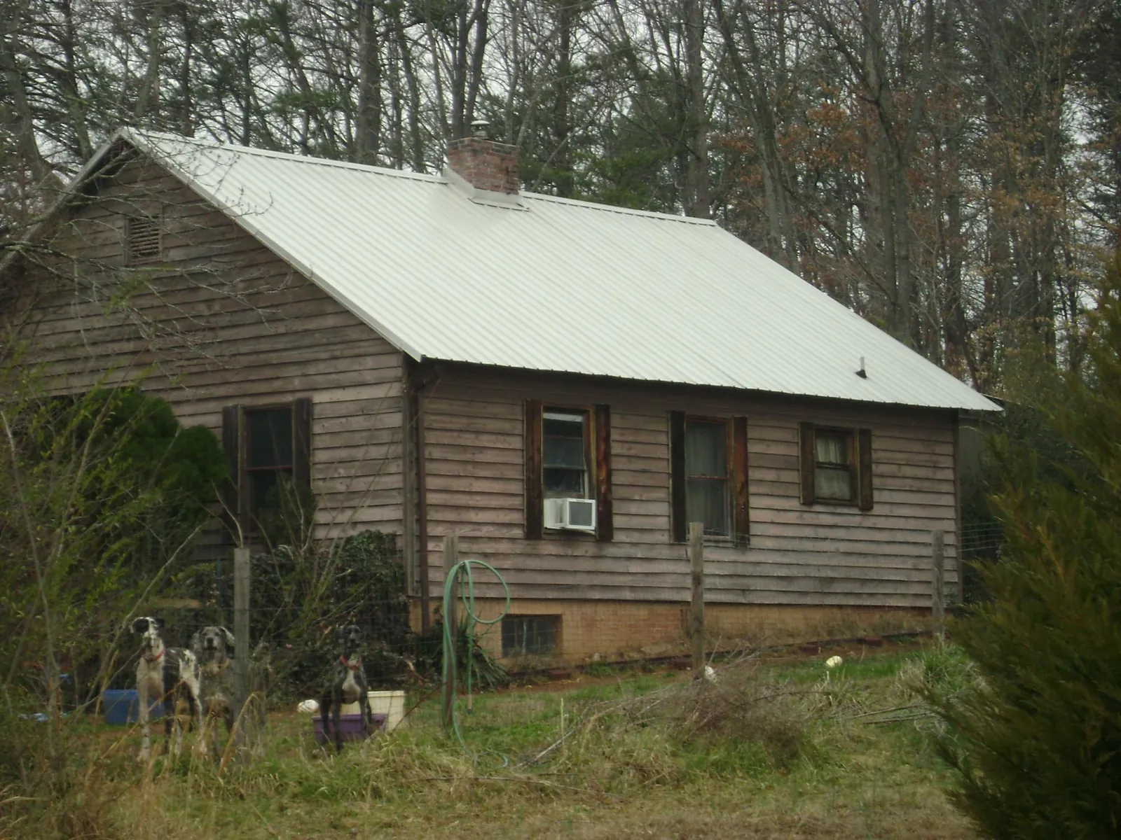 White metal roof on an old wood sided farmhouse, from a Metal Roof Installation job in Ranson